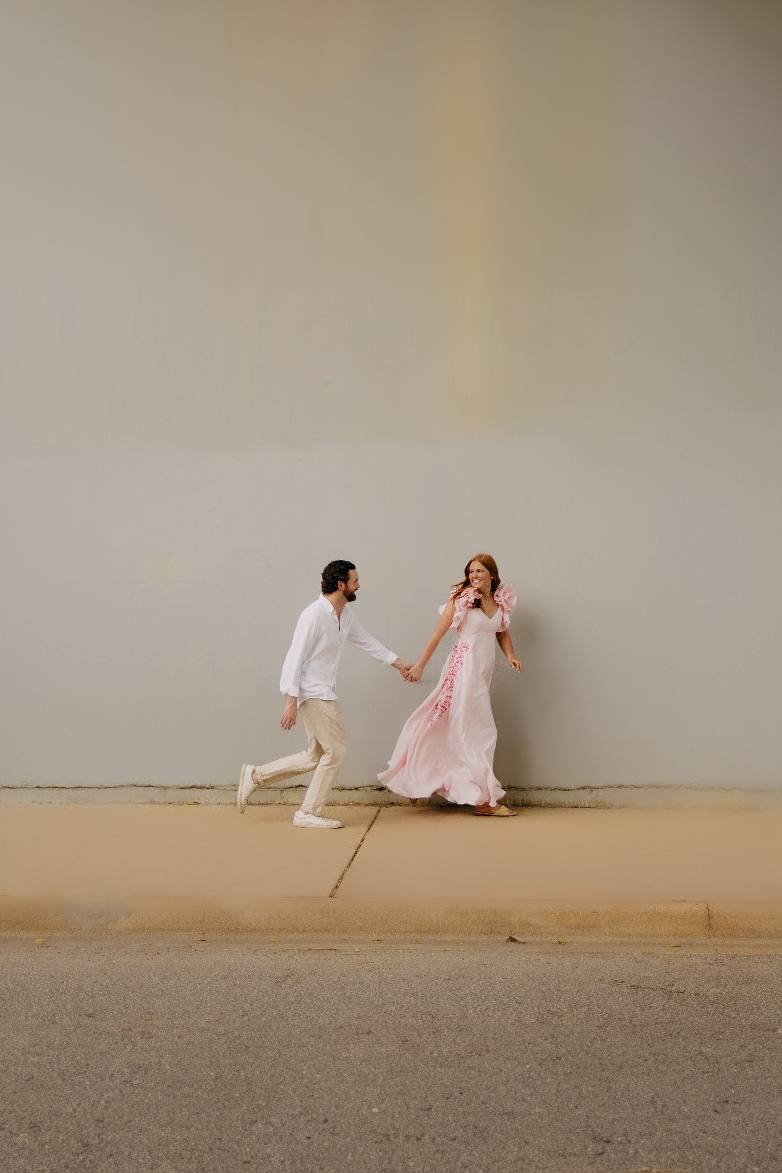A couple photographed together during an engagement session in downtown Austin, Texas